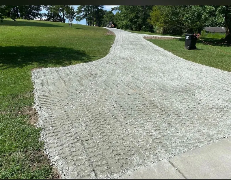 Fresh gravel spread for a long driveway through the lawn