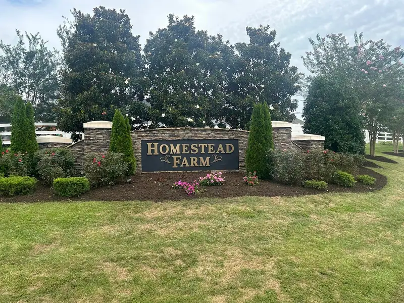 Neighborhood entrance bed with shrubs and flowers