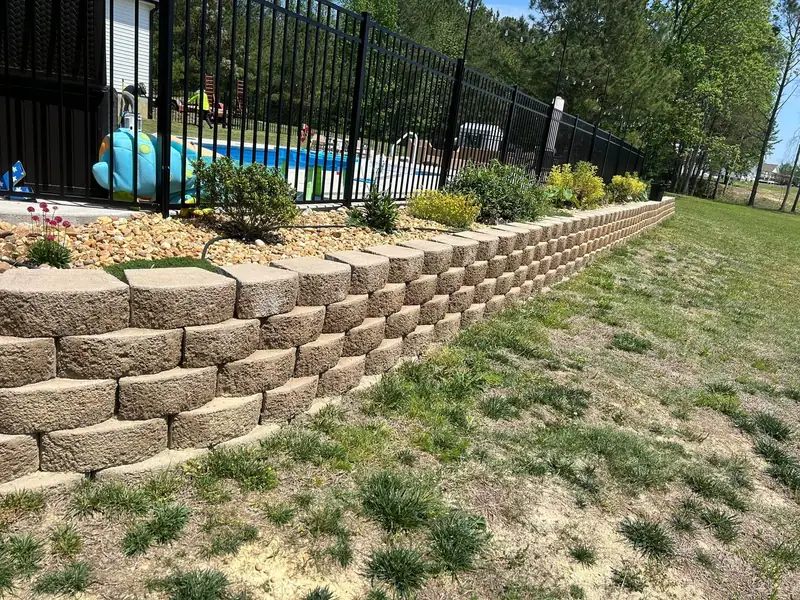 Long block retaining wall with a planted bed on top