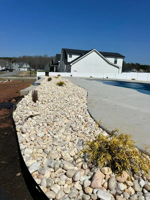 River rock border along a pool walkway