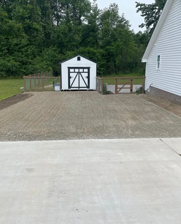 Graded gravel pad leading back to a new shed